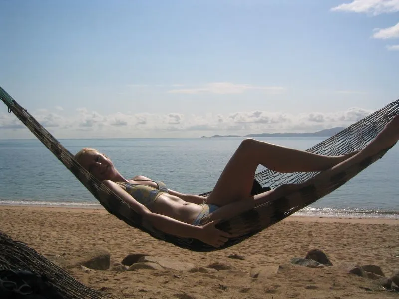Solo female traveler relaxing in a hammock